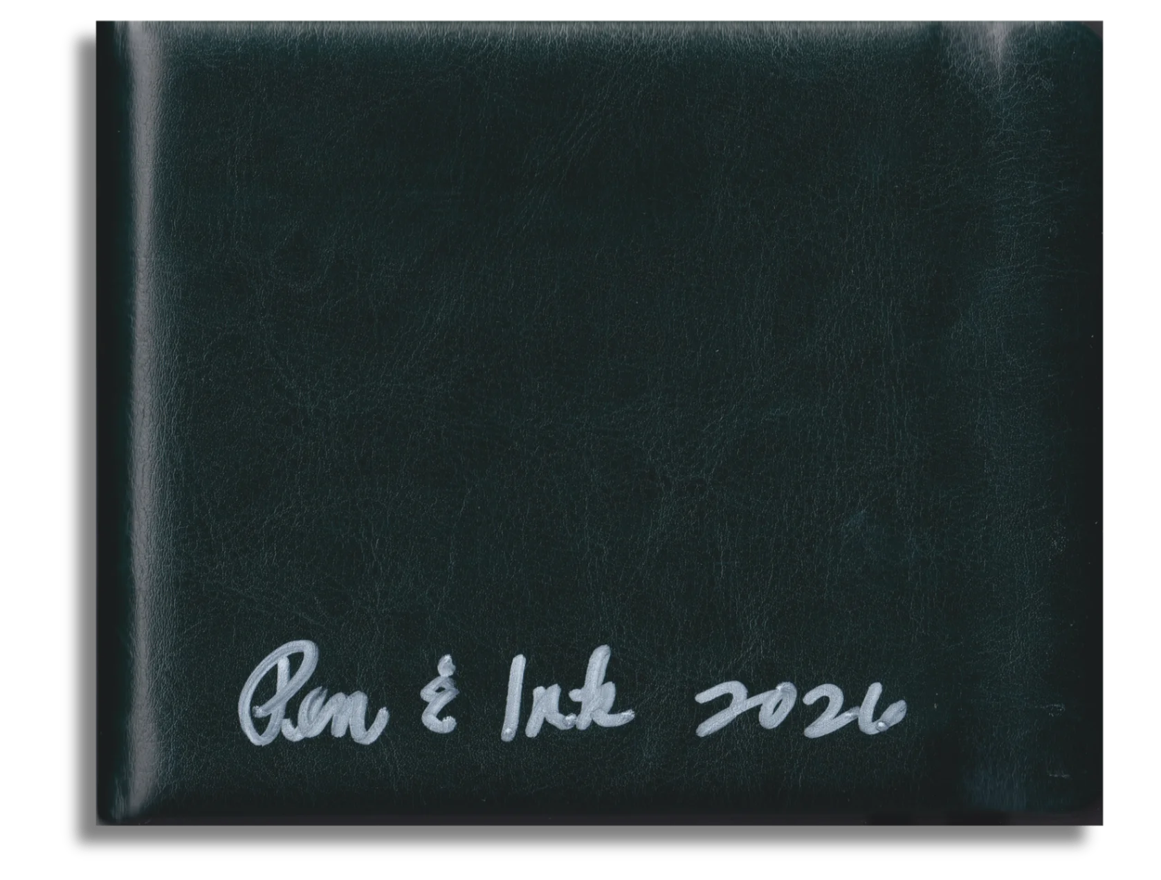 Pen & Ink 2026 sketchbook — dark green leather cover with handwritten silver title